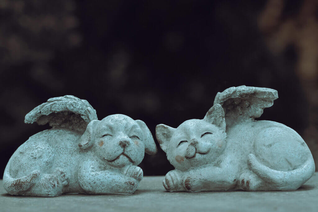 Kleine Stein-Statuen von Hund und Katze als Engel